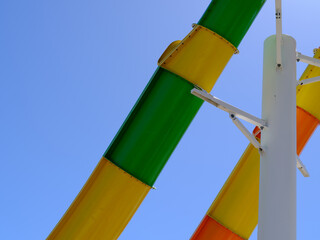 Abstract Graphic resource image of the bright colors of a tall water slide against a perfect blue sky in Virginia
