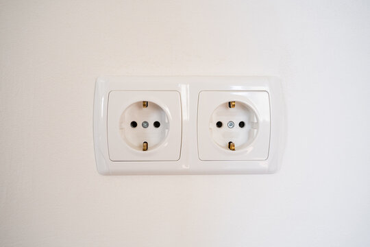 A white double electrical wall outlet. European type power socket on a white wall close-up. Standard power supply system for home, office, or industrial use. safe energy connection, electricity.