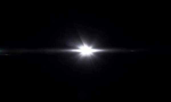 A strobe effect, bright flashing white light on a black background, random timing