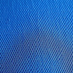 Close-up texture of classic blue denim fabric, showing weave detail, thread, jeans, indigo dye