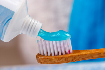 Application of toothpaste on toothbrush bristles