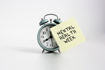 Alarm Clock Reminder for Mental Health Week. alarm clock with sticky note reading 