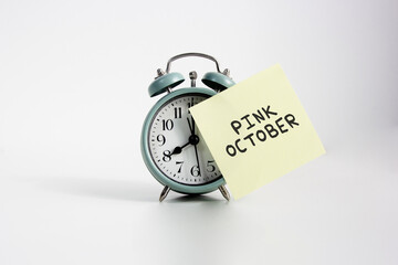 Alarm Clock Reminder for Pink October Awareness. alarm clock with sticky note reading 