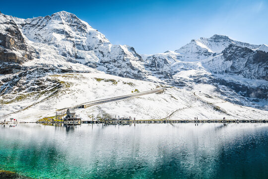 Turquoise Fallbodensee lake and high snowy mountains, Grindelwald, Switzerland