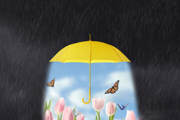 Butterflies flying over bright flowers under open yellow umbrella during heavy rain