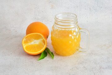 Orange Juice in a Glass with Oranges
