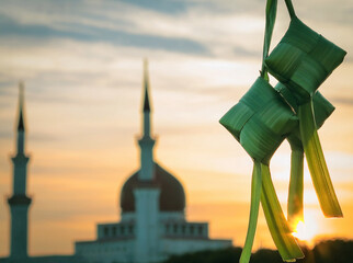 Three ketupats and a masjid in the morning. Ketupat is identical to the celebration of Eid al-Fitr and Eid al-Adha. Muslims will eat it during Eid with relatives.