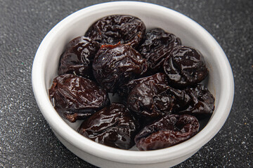 Dried prunes drained smoked plum delicious gourmet food background on the table rustic food top...