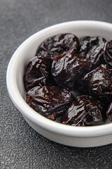 Dried prunes drained smoked plum delicious gourmet food background on the table rustic food top view copy space keto and paleo diet vegetarian and vegan food