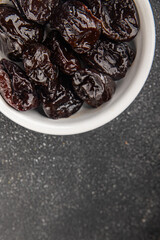 Dried prunes drained smoked plum delicious gourmet food background on the table rustic food top view copy space keto and paleo diet vegetarian and vegan food
