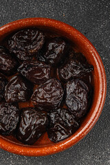 Dried prunes drained smoked plum delicious gourmet food background on the table rustic food top view copy space keto and paleo diet vegetarian and vegan food