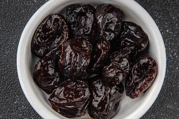 Dried prunes drained smoked plum delicious gourmet food background on the table rustic food top view copy space keto and paleo diet vegetarian and vegan food
