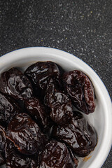 Dried prunes drained smoked plum delicious gourmet food background on the table rustic food top view copy space keto and paleo diet vegetarian and vegan food