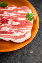 Bacon slices pork meat fresh delicious gourmet food background on the table rustic food top view copy space