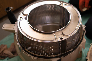 Plumber repairs the washing machine. Man fixes washing machine