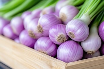 Fresh purple spring onions in a wooden crate