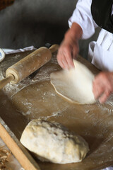 Rolling out the dough with the rolling pin