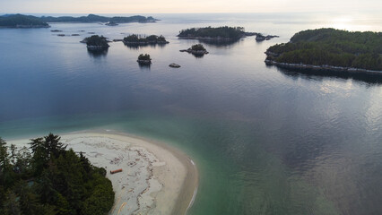 Sandy beach with view of small islands at dusk. Taken near Calvert Island, British Columbia