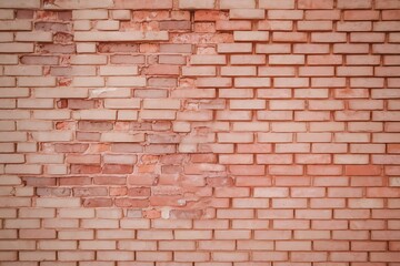 Naklejka premium Damaged Brick Wall Texture Showing Deterioration and Missing Bricks