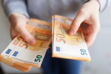 Hands holding euro cash, showcasing financial security and personal wealth.