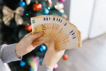 Hands showcasing euro banknotes, symbolizing monetary prosperity and security.