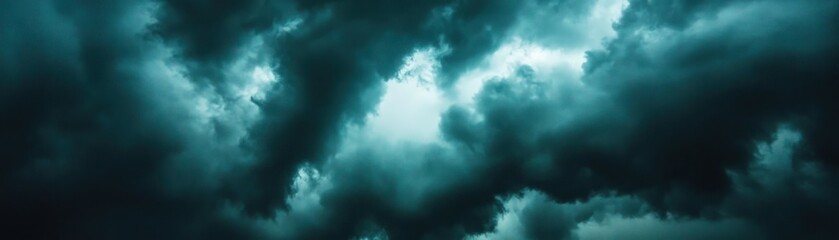 Fototapeta premium Dark moody clouds with bright opening in the sky
