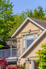 Top of luxury house with shingle roof, red and yellow trees and nice windows in Summer in Vancouver, Canada, North America. Day time on June 2024.