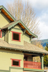 Top of luxury house with shingle roof, red and yellow trees and nice windows in Summer in Vancouver, Canada, North America. Day time on June 2024.