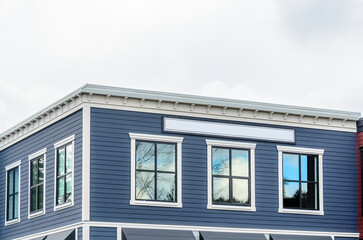 Top of luxury house with shingle roof, red and yellow trees and nice windows in Summer in Vancouver, Canada, North America. Day time on June 2024.