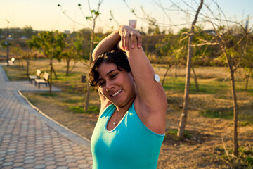 Diabetic patient woman doing exercises. Continuous Glucose Monitor and active sugar diabetes...