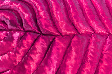 Leaf shaped fabric silk texture close-up background. Bright fuchsia color backdrop.
