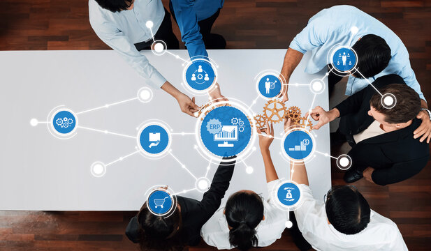 A dynamic business team engages in a collaborative meeting, utilizing technology concepts to enhance workflow and drive innovation in a modern office setting. Amity - Powered by Adobe