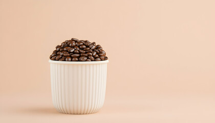 Roasted coffee beans in a white ribbed cup against a pale peach background