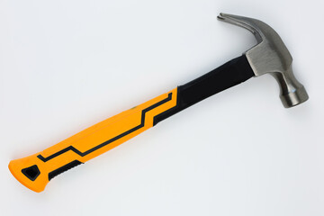 A hammer with an iron base and a yellow-black handle lies on a white background. The concept of repair, hammering. High quality photo