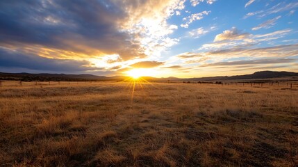 Fototapeta premium Breathtaking View of a Sunset Over Vast Open Field with Dramatic Clouds and Golden Light : Generative AI