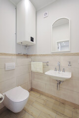 Toilet bowl and sink with mirror in the bathroom