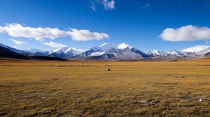 Breathtaking panoramic view of majestic snow capped mountains under a bright blue sky in a vast open landscape : Generative AI