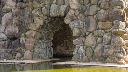 The entrance to the grotto, surrounded by water, among the rocks.