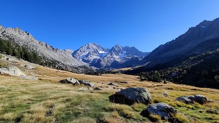 Obraz premium Breathtaking mountainous landscape with rolling hills and snow capped peaks under a clear blue sky : Generative AI