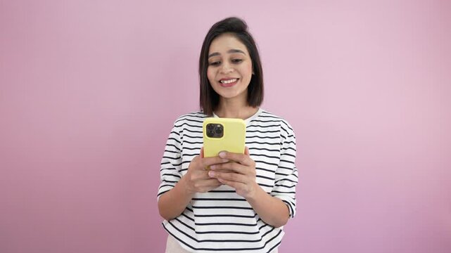 Happy South Asian woman browsing on a smartphone, overjoyed euphoria with amazed face expression
