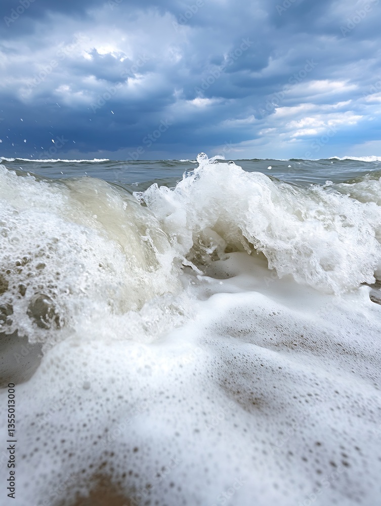 Poster dynamic ocean waves crashing on a sandy shore under a dramatic stormy sky filled with dark clouds : 