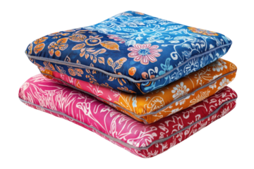 Vibrant floral cushions in a stack showcasing rich batik patterns and a soft, plush texture with shimmering silver trim.