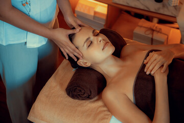 Caucasian woman enjoying relaxing anti-stress head massage and pampering facial beauty skin...