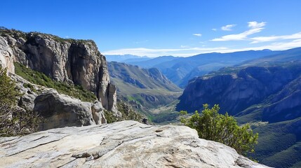 Fototapeta premium Breathtaking mountain valley view showcasing cliffs and a vibrant landscape under a clear blue sky : Generative AI