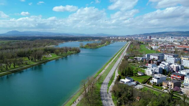 Aerial drone view of Park Jarun in Zagreb, showcasing stunning blue water, lush greenery, and the nearby Sava River Park features excellent bicycle roads, perfect for cycling and outdoor activities