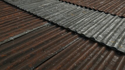 Close-up corrugated metal roof with rust & raindrops. Weathered metallic material shows oxidation. Building exterior texture evokes grungy, industrial concepts.