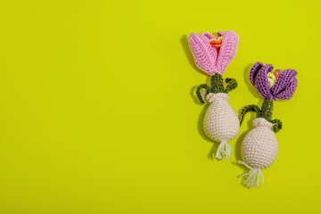 Spring planting and gardening concept. Handmade flowers with bulbs, mini tools, watering can, buckets