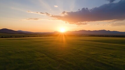 Breathtaking sunset view over rolling fields with vibrant rays of sunlight piercing through cloudy skies : Generative AI