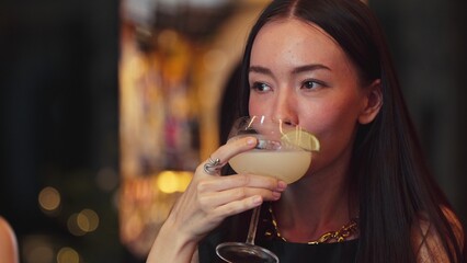 Smiling beautiful woman zipping Margarita cocktail savoring tasty drink making special time by bartender at luxurious bar creating moment meeting with friends or a couple vibrant nightclub. Vinosity. © InfiniteFlow