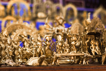 An intricate golden sculpture, possibly depicting a historical or religious scene, with detailed craftsmanship and cultural significance.